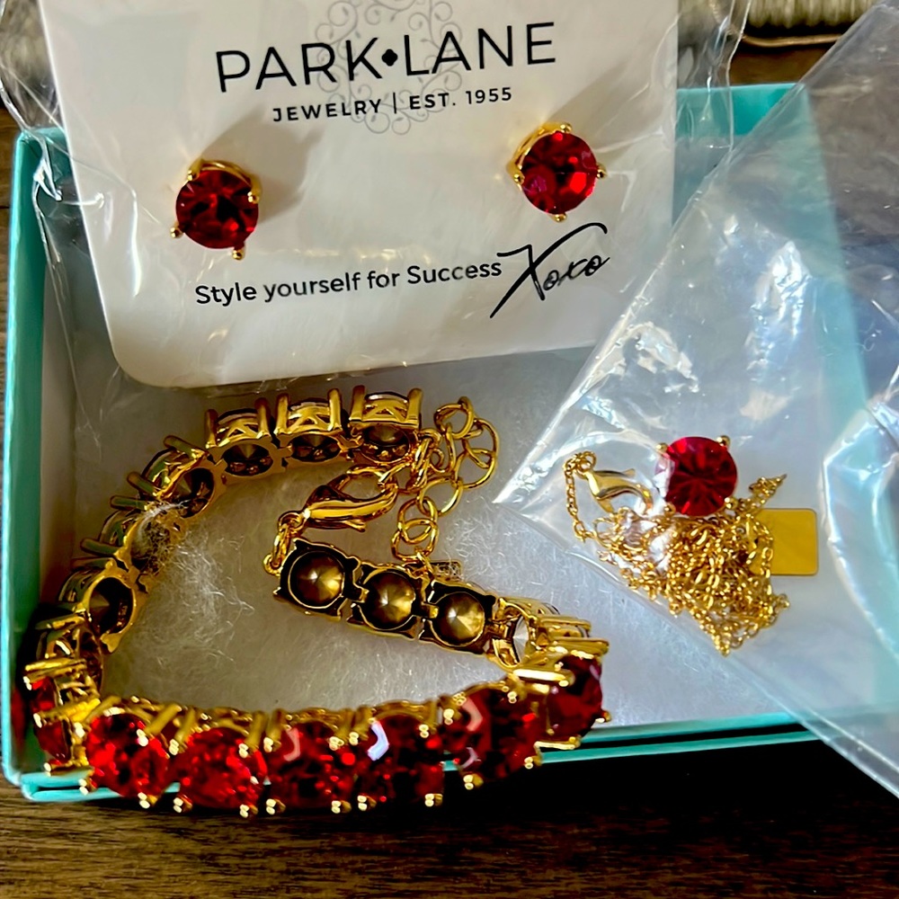 Brand new necklace earring and bracelet set red round stone and gold tone